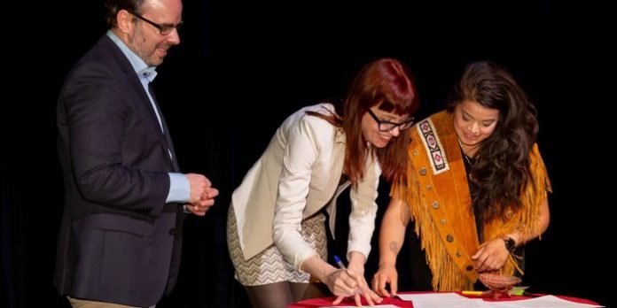 In a ceremony earlier this month, Indigenous playwright Kim Senklip Harvey (right) signed a living treaty with Vancouver's Arts Club Theatre Company and Edmonton’s Citadel Theatre, represented here by Daryl Cloran (left) and Ashlie Corcoran (centre). Photo by Mark Halliday.